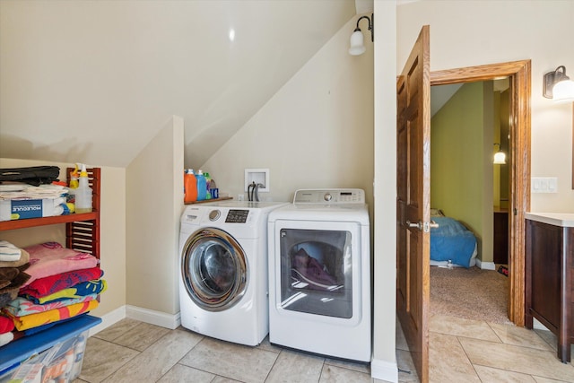 laundry room featuring light tile patterned flooring and washing machine and clothes dryer