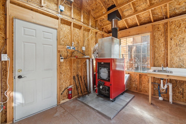 misc room featuring a wood stove and sink