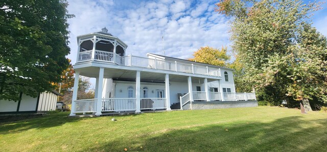 5578 Lake Shore Dr, Weidman, MI 48893 - back of property featuring a porch, a balcony, and a yard