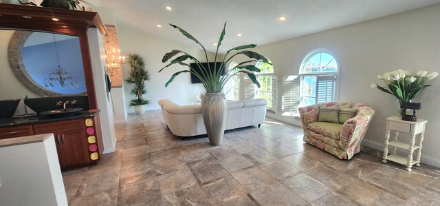 5578 Lake Shore Dr, Weidman, MI 48893 - living area with recessed lighting, light stone finish flooring, a chandelier, and baseboards