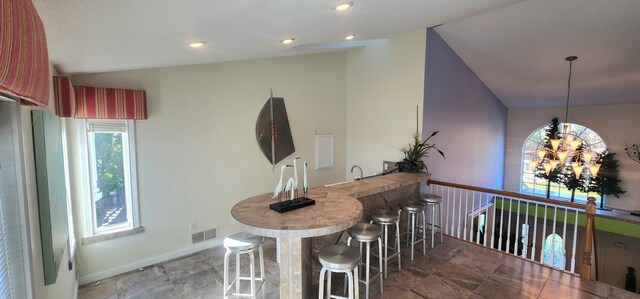 5578 Lake Shore Dr, Weidman, MI 48893 - dining room with wet bar, a chandelier, baseboards, vaulted ceiling, and recessed lighting