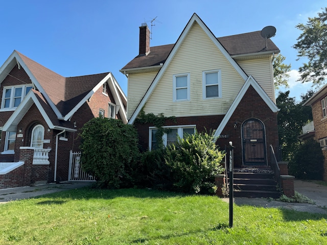 tudor-style house with a front lawn