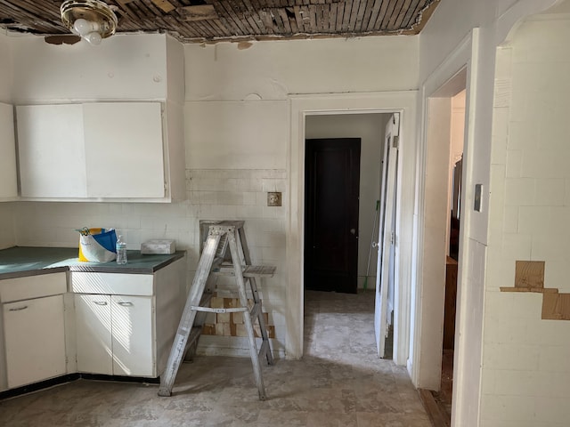 kitchen featuring white cabinets and ceiling fan