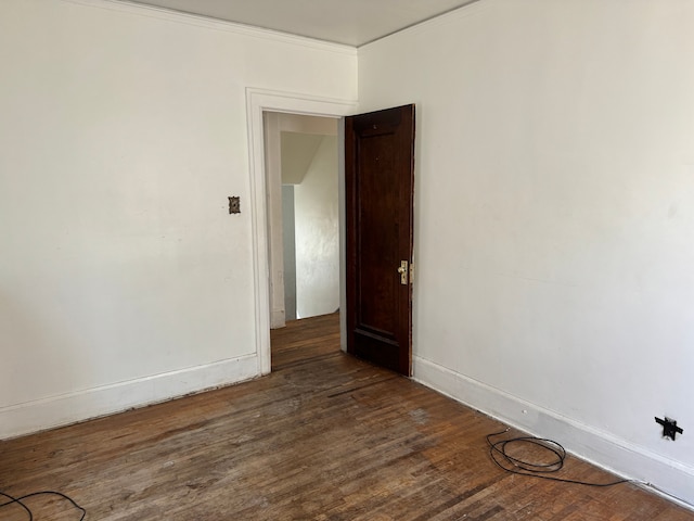 unfurnished room with dark hardwood / wood-style floors and ornamental molding