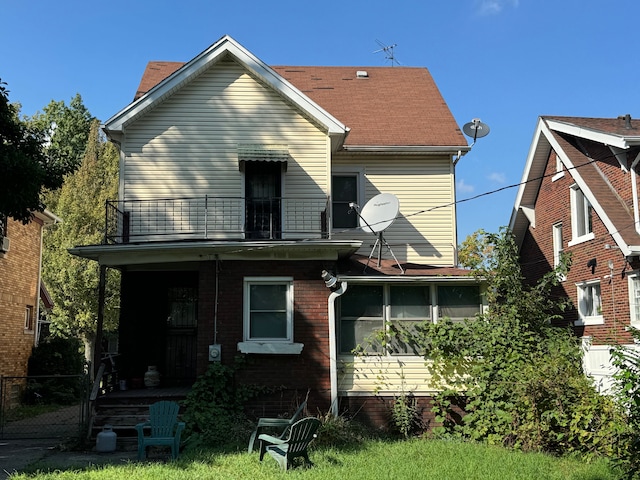 rear view of property with a balcony