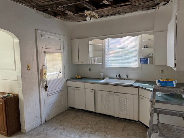 kitchen featuring a wealth of natural light, white cabinetry, and sink