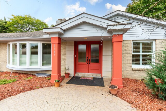 4345 Pine Tree Trl, Bloomfield Hills, MI 48302 - doorway to property featuring brick siding, french doors, roof with shingles, and a chimney