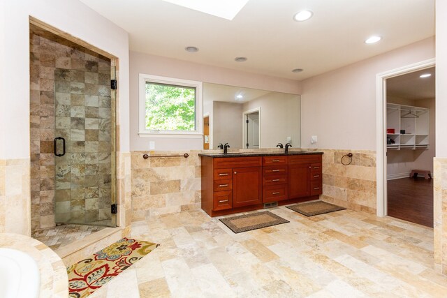 4345 Pine Tree Trl, Bloomfield Hills, MI 48302 - bathroom featuring tile walls, double vanity, a shower stall, a wainscoted wall, and recessed lighting