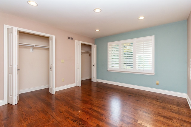 4345 Pine Tree Trl, Bloomfield Hills, MI 48302 - unfurnished bedroom with two closets, recessed lighting, wood finished floors, and baseboards