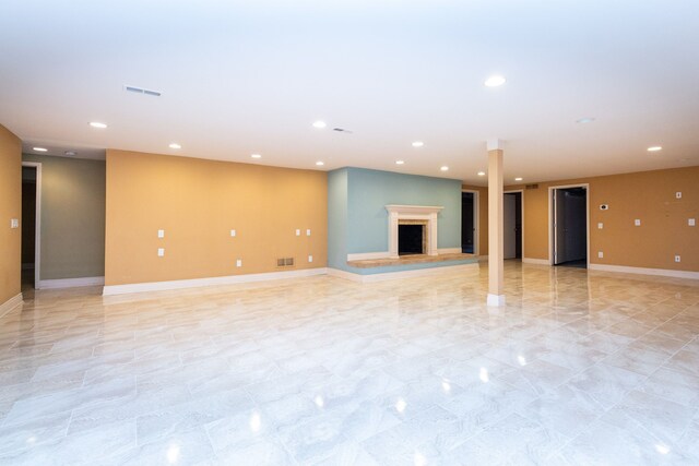 4345 Pine Tree Trl, Bloomfield Hills, MI 48302 - unfurnished living room featuring baseboards, a fireplace with raised hearth, and recessed lighting