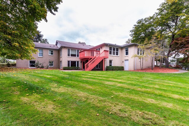 4345 Pine Tree Trl, Bloomfield Hills, MI 48302 - rear view of property featuring stairs, a deck, brick siding, and a yard