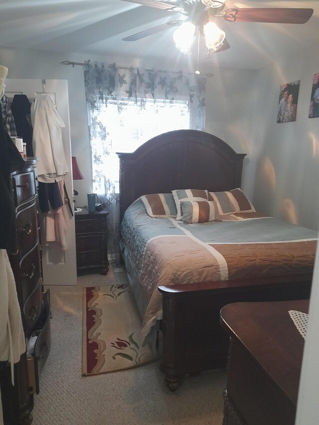 bedroom with ceiling fan and carpet