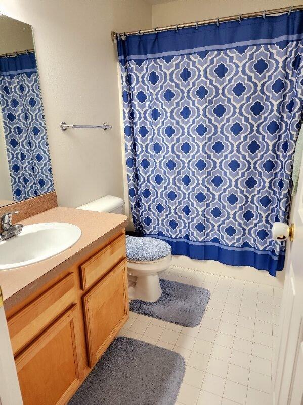 bathroom featuring tile patterned floors, vanity, and toilet