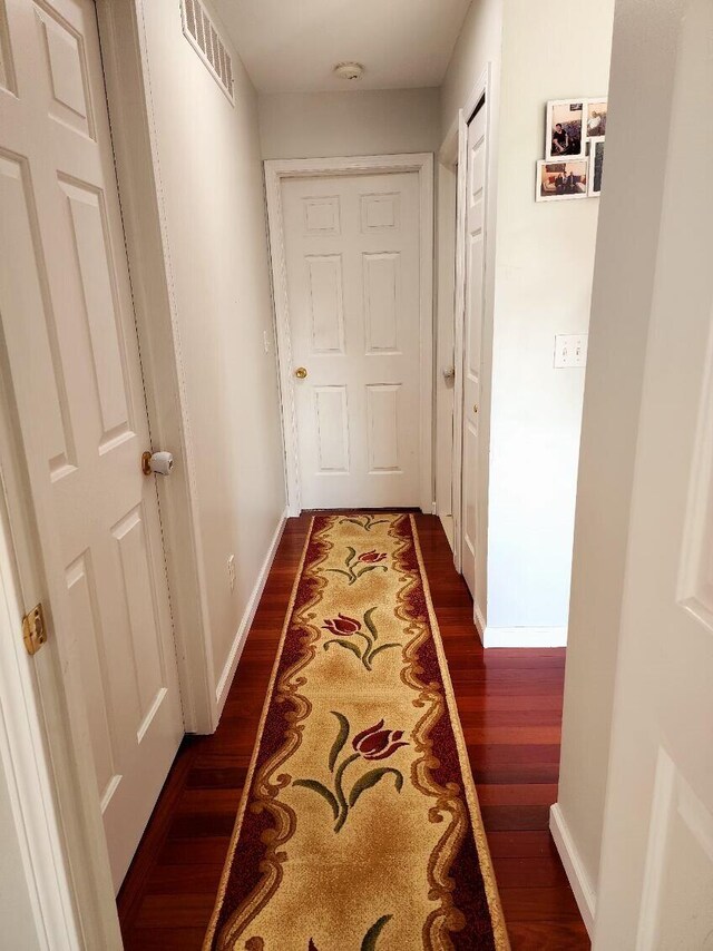 hallway featuring dark hardwood / wood-style flooring