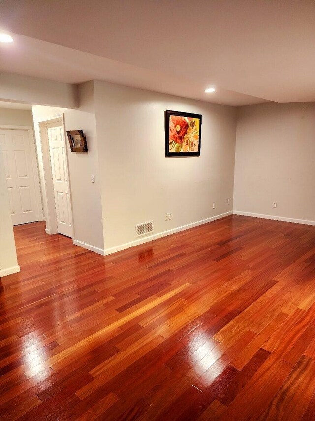 spare room with wood-type flooring