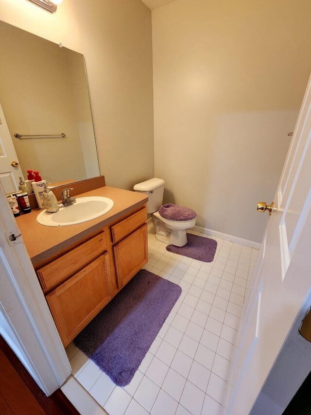 bathroom featuring tile patterned floors, vanity, and toilet