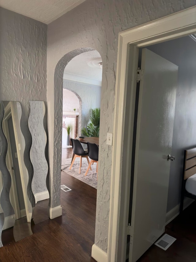 corridor featuring dark hardwood / wood-style floors and a textured ceiling