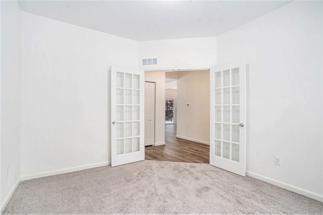 empty room with carpet flooring and french doors