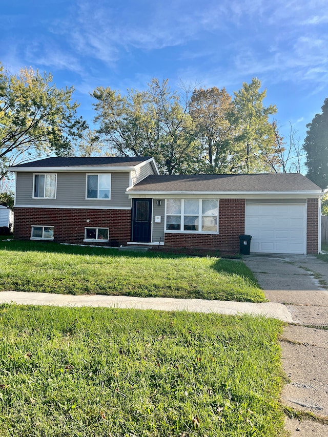 view of front of property featuring a garage and a front lawn