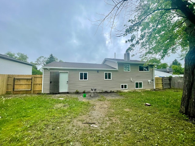 rear view of property with a yard