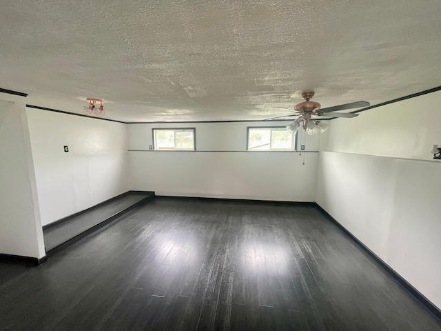 unfurnished room featuring a textured ceiling, dark hardwood / wood-style flooring, and ceiling fan