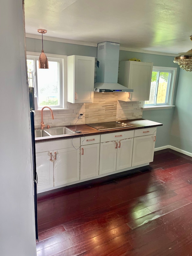 kitchen featuring pendant lighting, white cabinetry, and exhaust hood