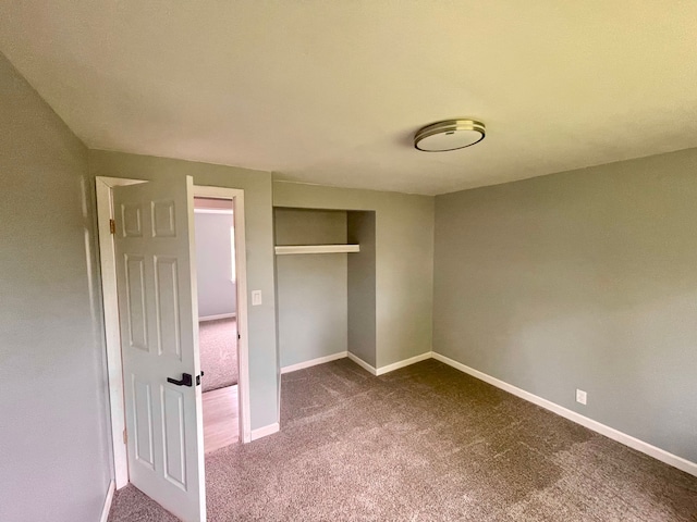 unfurnished bedroom with carpet and a closet