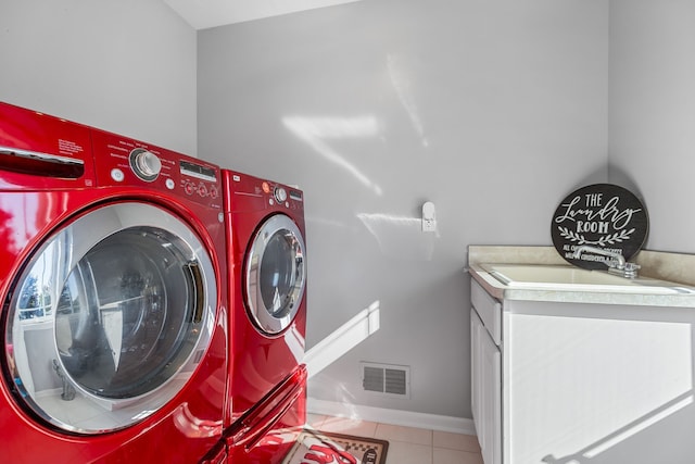 laundry area featuring light tile patterned floors and washer and clothes dryer