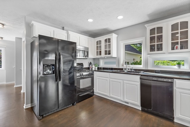 kitchen with sink, white cabinetry, and black appliances