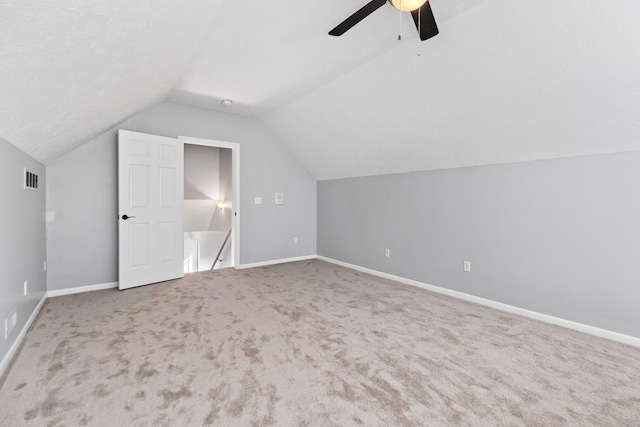 additional living space with ceiling fan, lofted ceiling, and carpet floors