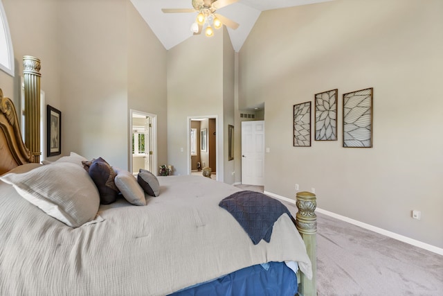 bedroom featuring carpet, ceiling fan, high vaulted ceiling, and ensuite bath