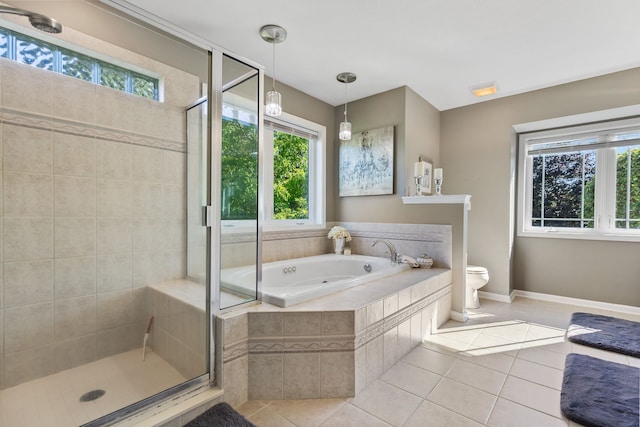 bathroom featuring tile patterned floors, separate shower and tub, and toilet