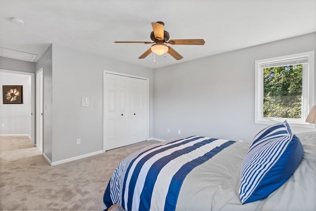 carpeted bedroom featuring a closet and ceiling fan