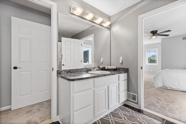 bathroom with vanity, a textured ceiling, and ceiling fan