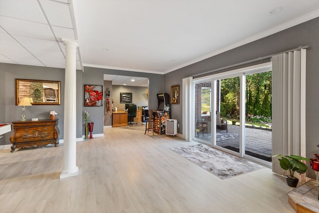 interior space with ornate columns, crown molding, and light hardwood / wood-style floors