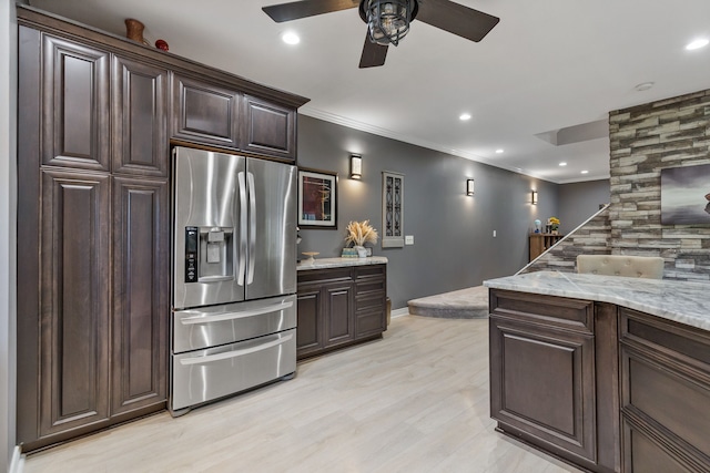 kitchen with light stone countertops, dark brown cabinetry, stainless steel refrigerator with ice dispenser, and light hardwood / wood-style flooring