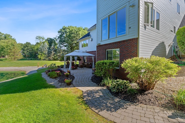 view of home's exterior with a lawn and a patio