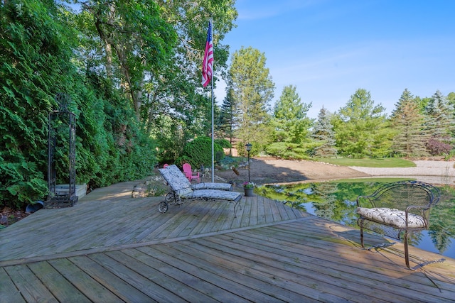 wooden terrace featuring a water view