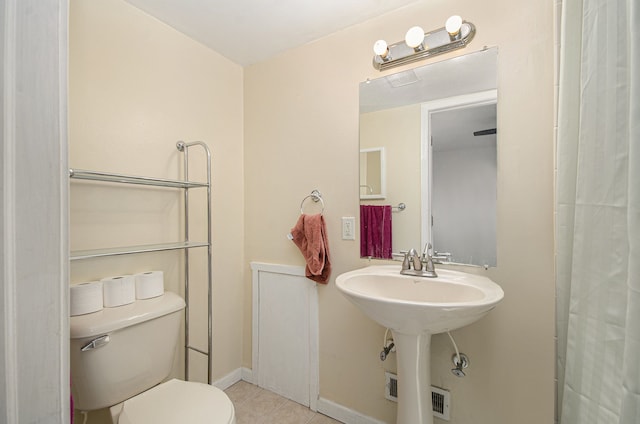 bathroom featuring tile patterned floors and toilet