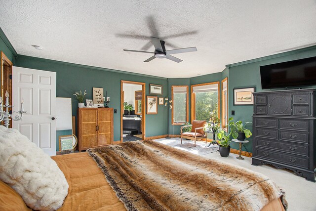 bedroom with ceiling fan, ensuite bathroom, crown molding, carpet floors, and a textured ceiling