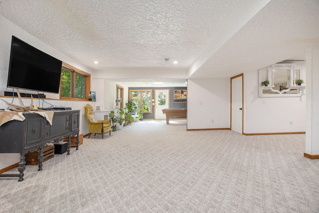 living room featuring carpet, french doors, a textured ceiling, and pool table