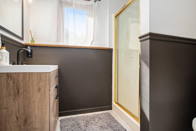 bathroom with vanity and a shower with shower door