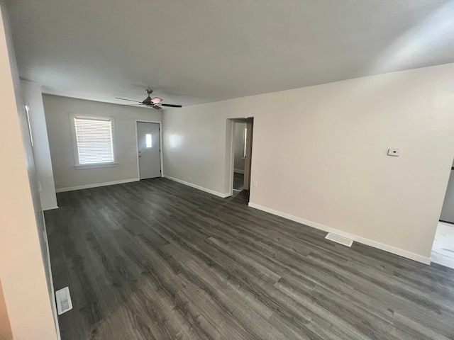 unfurnished living room featuring dark hardwood / wood-style flooring and ceiling fan