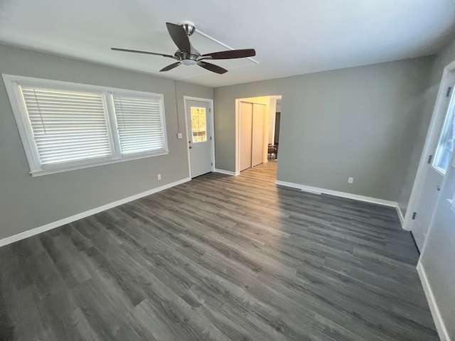 interior space with dark hardwood / wood-style floors and ceiling fan