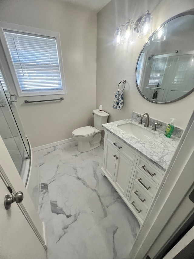 bathroom with vanity, toilet, and an enclosed shower