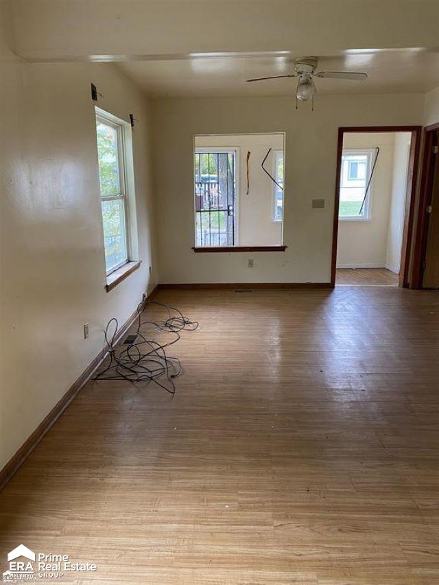 spare room featuring light wood-type flooring and ceiling fan