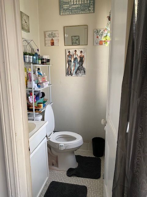 bathroom with tile patterned flooring, vanity, and toilet