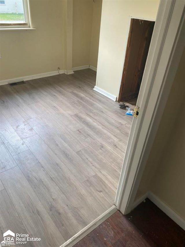 spare room with light hardwood / wood-style floors