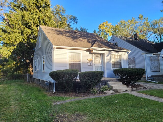 15836 Patton St, Detroit, MI 48223 - bungalow featuring a front yard and a shingled roof