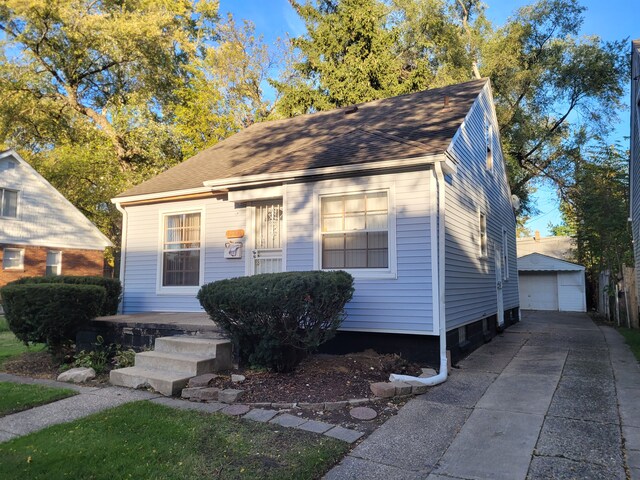 15836 Patton St, Detroit, MI 48223 - view of front facade featuring an outdoor structure, a garage, and roof with shingles